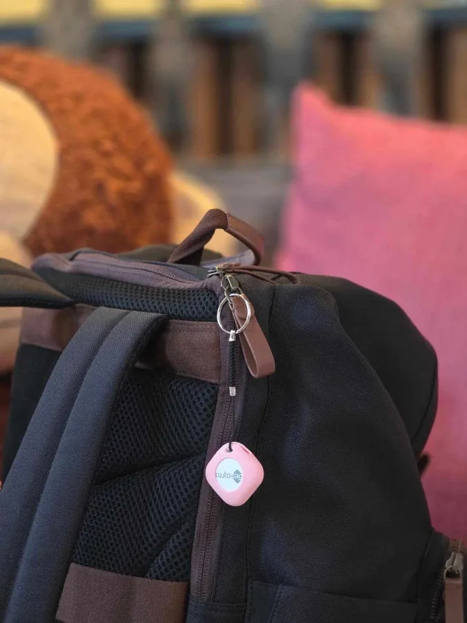 Custo CustoTag for iOS — Apple Find My tracker tag clipped to a bag